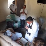 Fr.-Jilberto-Tzaj-anointing-a-sick-woman-in-San-José-Esposo-Mission.-La-Ceiba