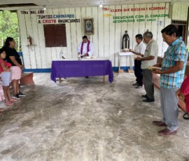 2025 Peru - Fr. Carlos Roman is celebrating the Eucharist in a community on the banks of the River Tigre.